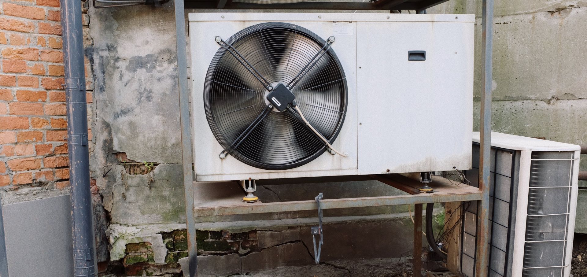 Air conditioner unit near wall of modern building on street
